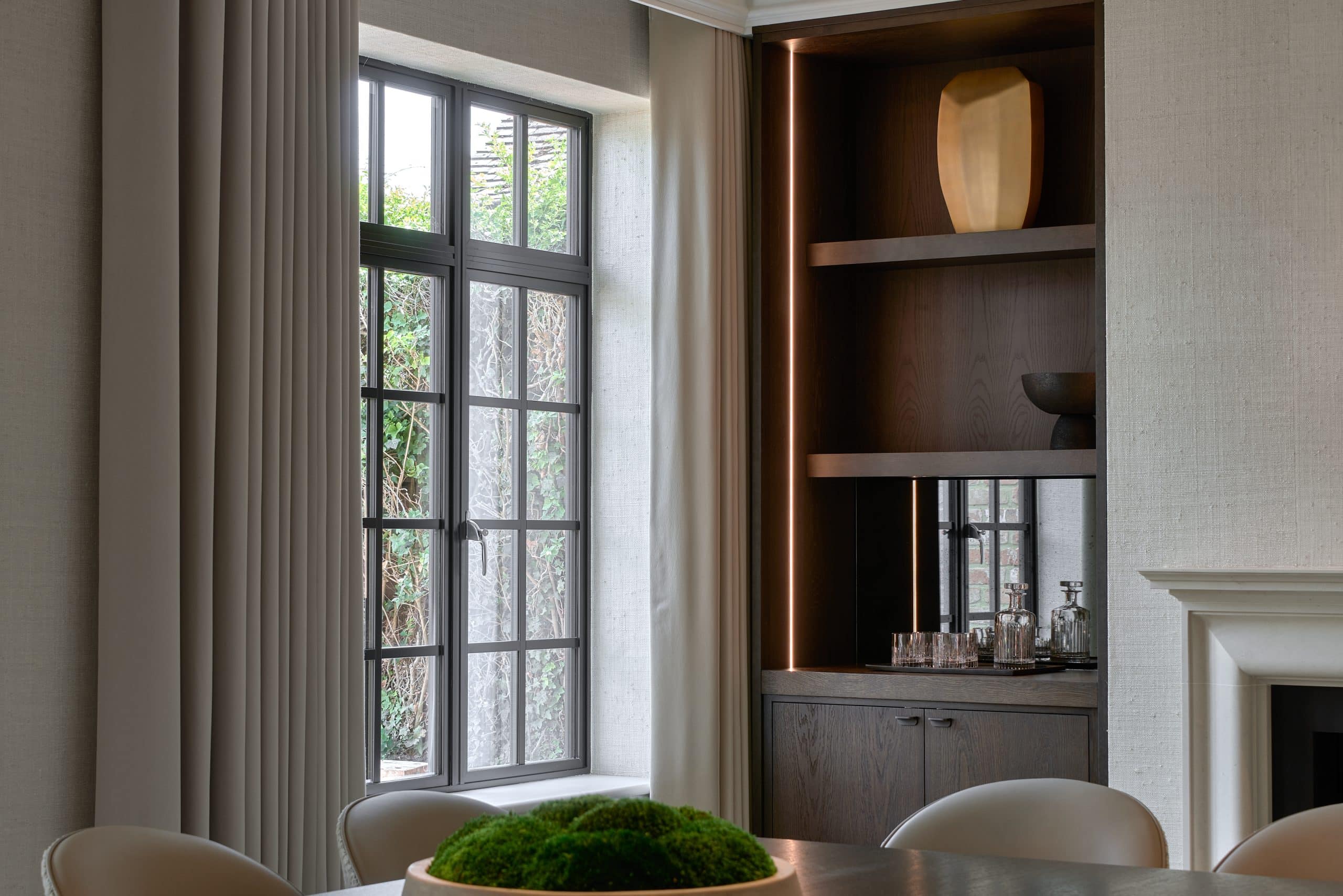 Luxury dining room with bespoke shelving and lighting in Kent